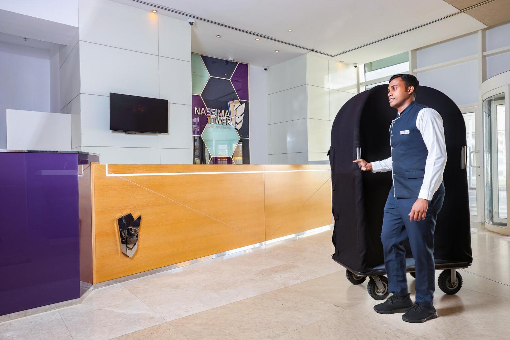 Nassima Tower Hotel Apartments Dubai Exterior foto A bellboy with a luggage cart
